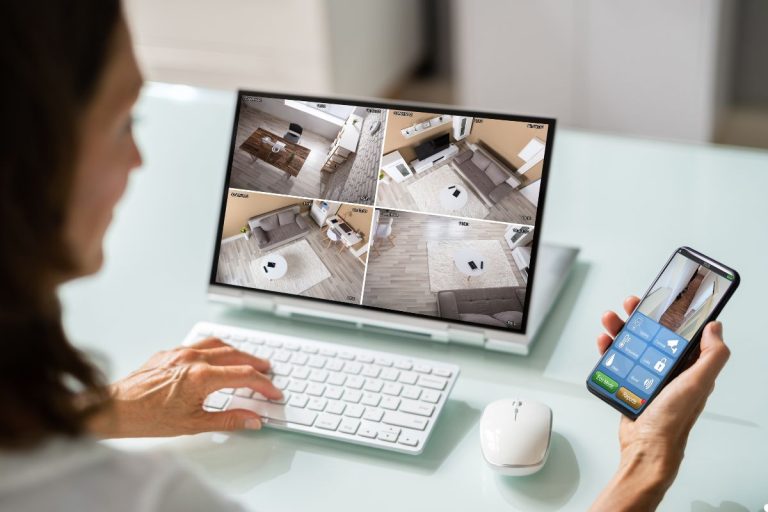 A hand reaches out to touch a smart home device, indicating user engagement with technology in a modern setting.